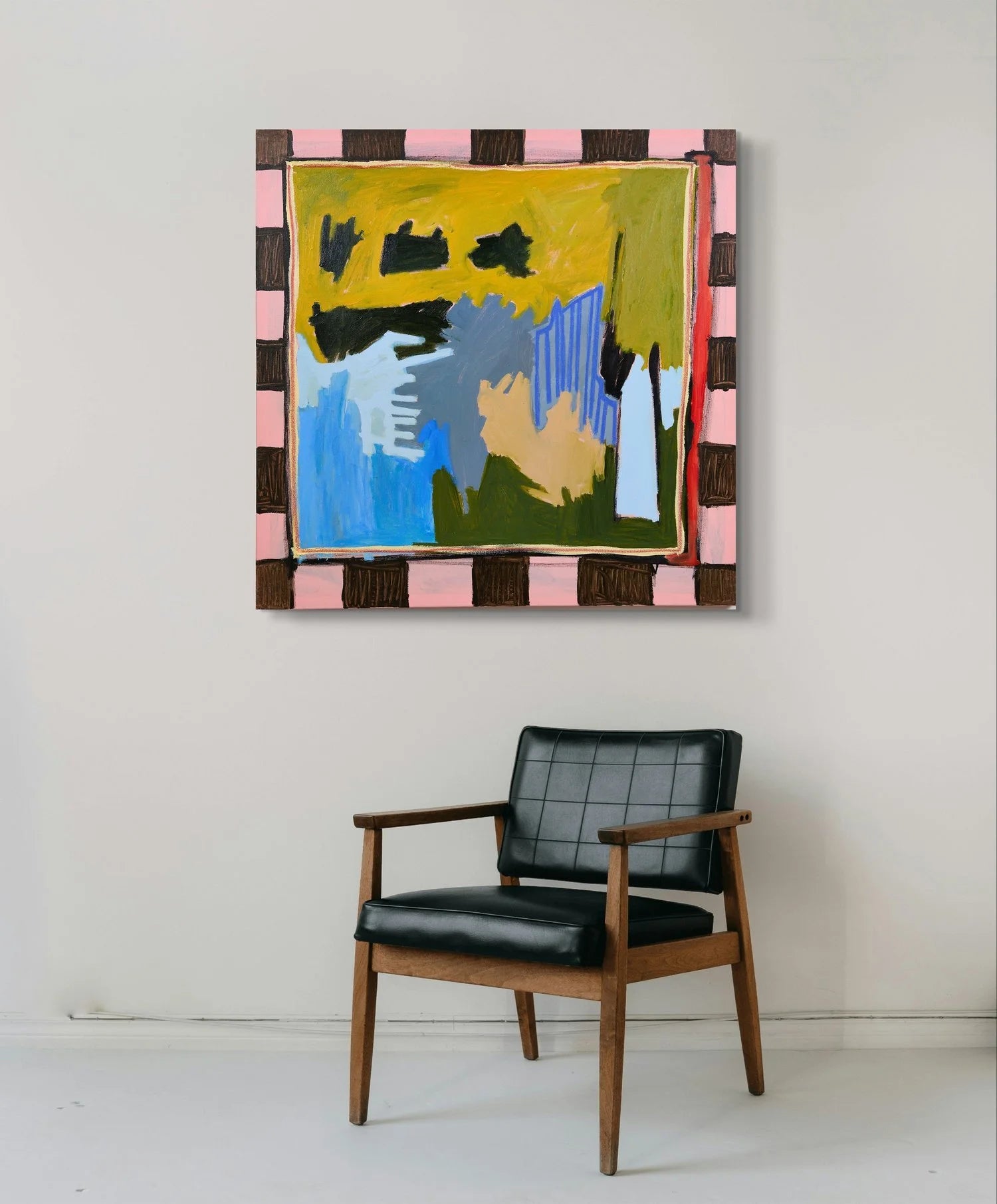 Sold Abstract painting by Marley Alvarez, vibrant and colourful with a black chair below it on a white background