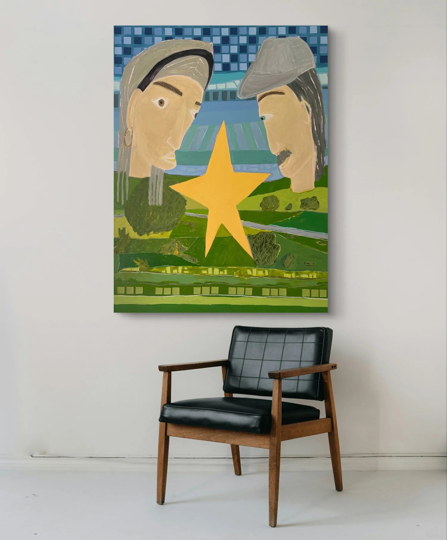 'Our Meeting Place' painting by Marley Alvarez. Painting of two faces with a yellow star on a wall above a black chair.