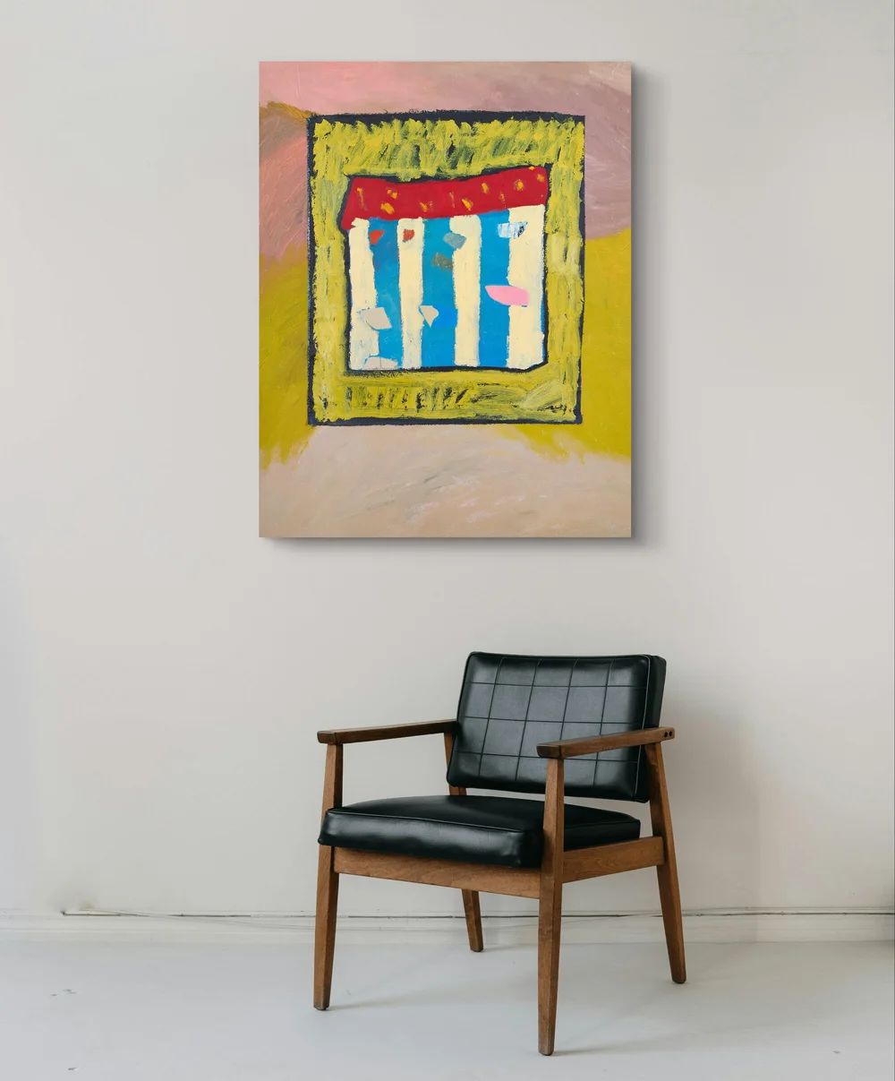 Abstract painting on a wall above a black chair
