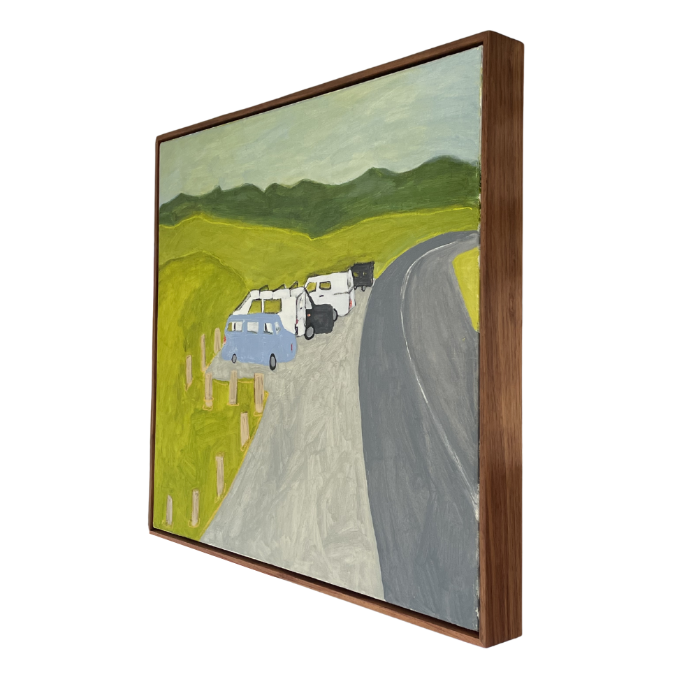 Framed artwork of a road with vehicles and green landscape