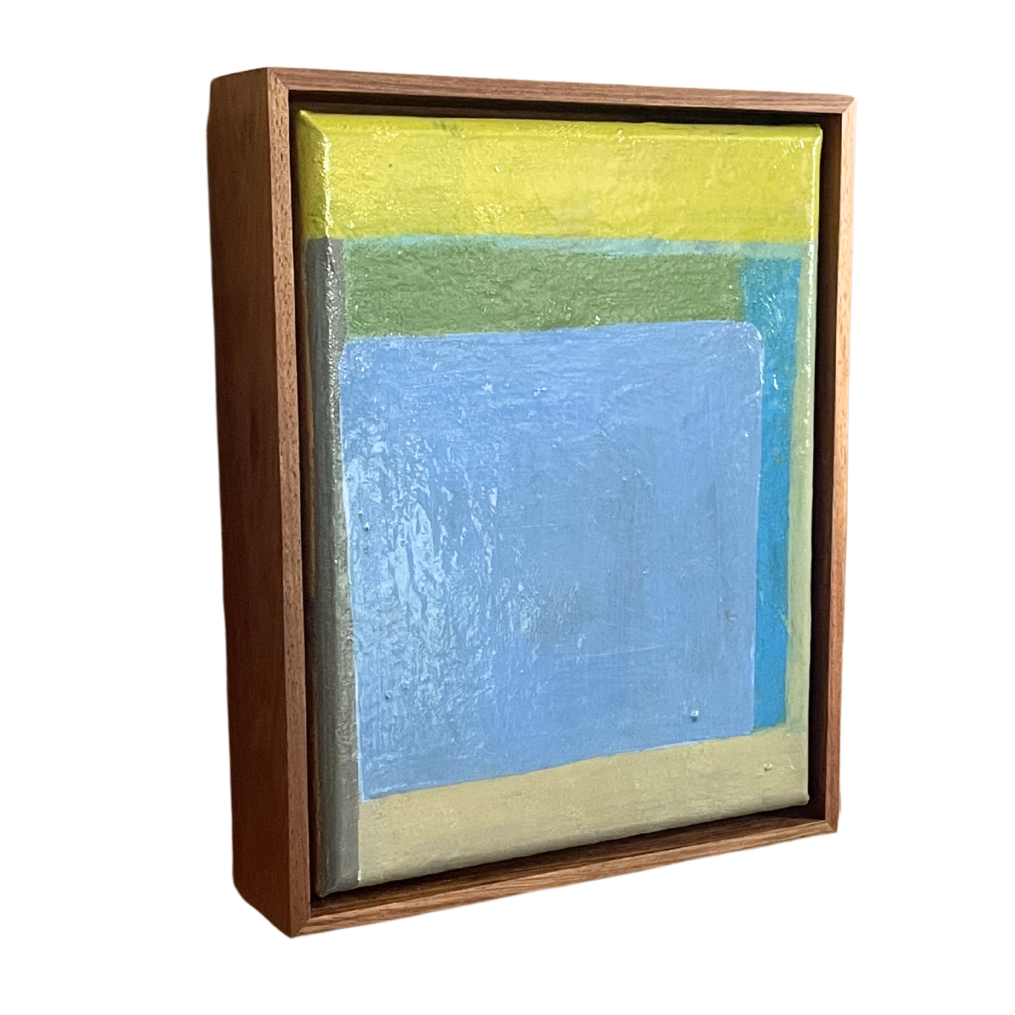 Abstract painting with blue and yellow colors in a wooden frame on a white background