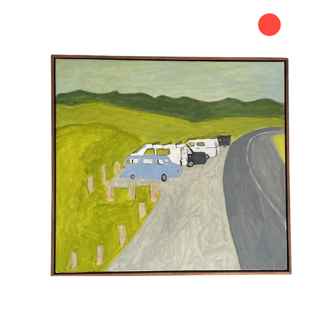 Framed artwork of a road with cars and green fields, under a red dot on a white background.