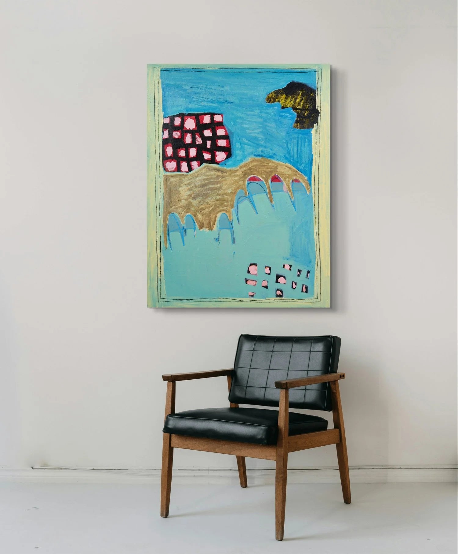 Black armchair in front of a colourful abstract painting on a white wall. Blue, brown red, black abstract painting by Marley Alvarez from the collection 'Back In Oz'